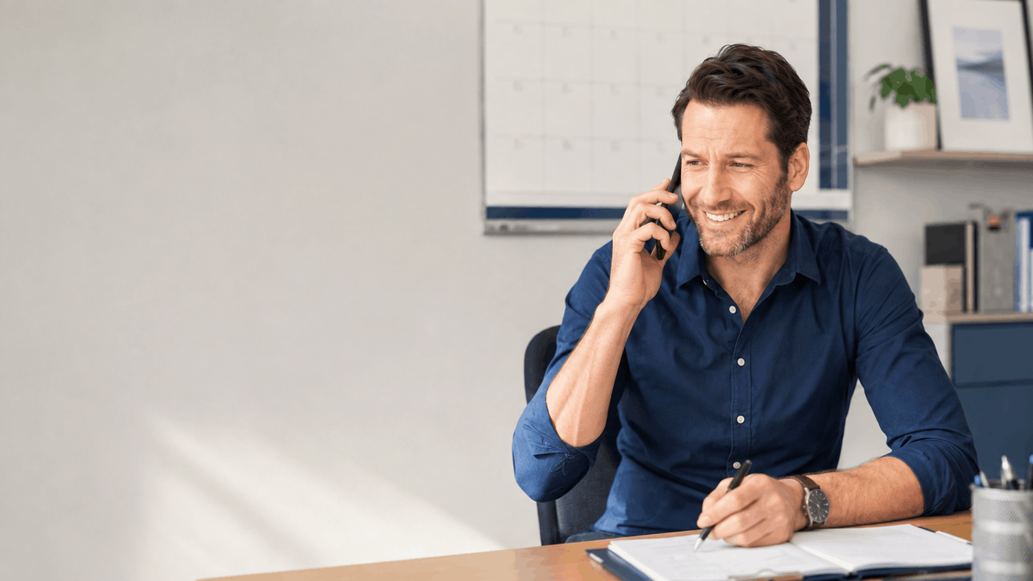 Local+business+owner+talking+with+potential+client+on+phone